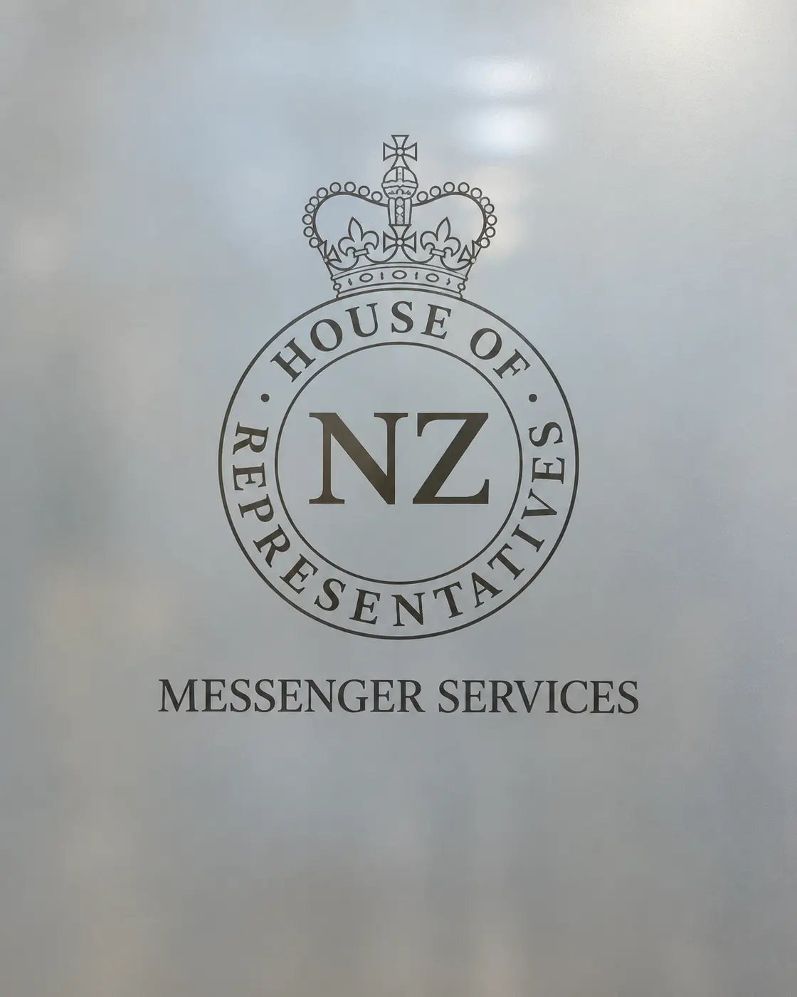 Glass door at Parliament etched with the House of Representatives crest and the words Messenger Services